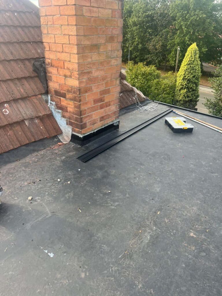 This is a photo of a flat roof which has just been repaired, there is also a chimney stack and some leadwork has also been dressed. Works carried out by LJ Roofing Freshbrook