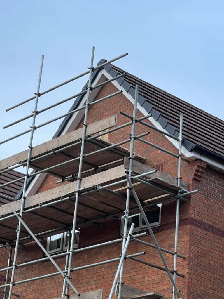 This is a photo of a roof which has just been repaired. There is a scaffold located at the gable end for access onto the roof. Works carried out by LJ Roofing Freshbrook